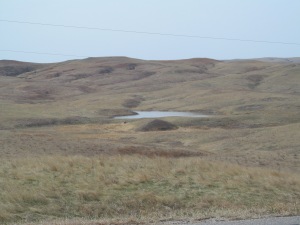 A water hole at the bottom of the buttes.